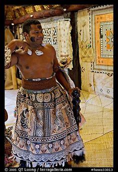 a man in an elaborate skirt is talking on the phone