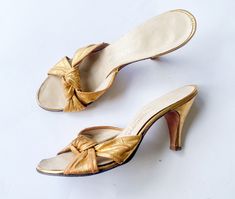 "~ 1950s beautiful gold metallic leather slides ~ Peep toe low heel style ~ Kitten heel sandals ~ Good leather soles ~ Some scuffs on side of heels only ~ Very nice Label:  I.Magnin & Co.  8 N Length- 9.75\" (24.65 cm) Width- 3\" (7.62 cm) Heel- 3.5\" (8.89 cm) More Incredible Vintage:  glennasvintageshop.etsy.com Vintage Jewelry:  glennasjewels.etsy.com Instagram @glennas_clothing Facebook  https://www.facebook.com/glennasclothing" Vintage High Heel Kitten Heels For Spring, Vintage Kitten Heels For Spring, Vintage Kitten Heels For Summer, Vintage High Heel Kitten Heels For Summer, Vintage Gold Heels For Spring, Vintage Gold Sandals For Evening, Vintage Gold Sandals For Formal Occasions, Vintage Low Heel Formal Sandals, Vintage Low Heel Sandals For Formal Occasions