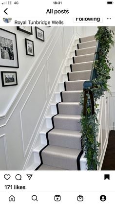 the stairs are decorated with greenery and pictures