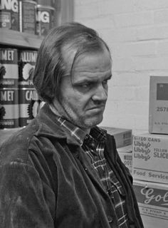 a man standing in front of stacks of boxes