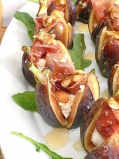 figs with prosciutto and cheese on a white plate