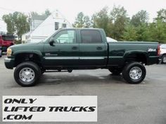 a green truck parked in a parking lot next to other cars and trucks with the words only lifted trucks com on it