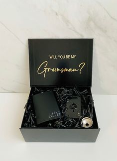 the groomsmen gift box is filled with personalized flasks and hip flasks