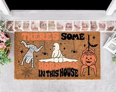 a door mat that says, there's some horror in this house