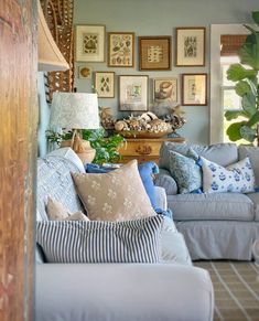 a living room filled with furniture and pictures on the wall