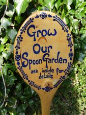 a wooden sign that says grow our spoon garden