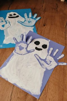 two handprints made to look like ghostes on the floor with blue and white paper