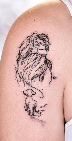 a woman's shoulder with a tattoo of a fish and a dog on it