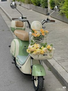 a scooter with flowers in the basket is parked on the street