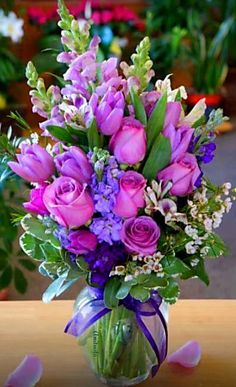 a vase filled with purple flowers on top of a table