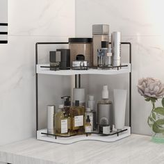 a bathroom shelf with various items on it and a vase next to it, in front of a marble wall