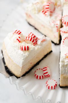 a slice of peppermint cheesecake on a white plate with candy canes