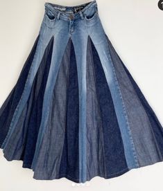 a skirt made out of jeans is hanging on the wall