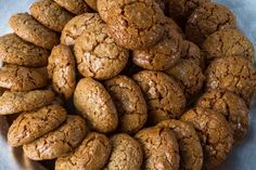 a plate full of cookies sitting on top of a blue table cloth with white trim