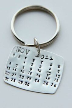 a metal key chain with a calendar on it