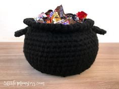 a black crocheted basket filled with candy