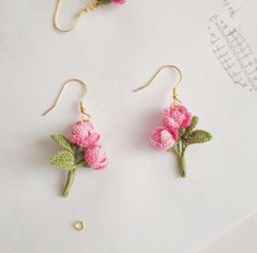 two pairs of earrings with pink flowers on them