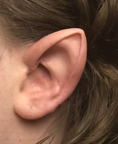 a close up of a person's ear with something in the middle of it