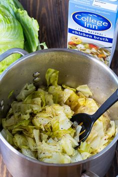 a pot filled with cabbage next to a carton of coleslaw on top of a wooden table