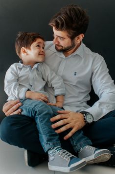 a man holding a small boy in his lap