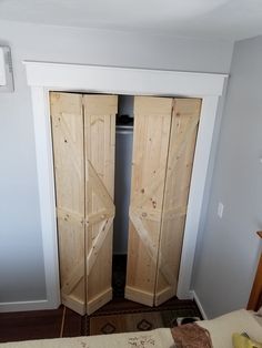 two wooden doors are open in a bedroom