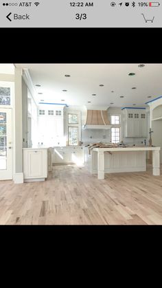 an empty kitchen with white cabinets and wood floors is shown in this instagramtion