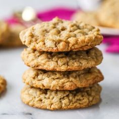 a stack of cookies sitting on top of a table next to a bowl of oatmeal