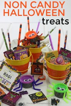 halloween buckets filled with candy and decorations