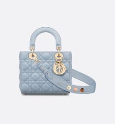 The Lady Dior My ABCDior bag epitomizes Dior's vision of elegance and beauty. Sleek and refined, the timeless style is crafted in pale blue lambskin with Cannage stitching, creating the unmistakable quilted texture. Pale gold-finish metal D.I.O.R. charms offer elegant appeal. Featuring a strap that can be personalized with symbolic badges, the small, unique design may be carried by hand or worn crossbody.. Lady Dior My Abcdior Bag, Dior Star, Dior And I, Icon Shoes, Dior Book Tote, Small Lady, Christian Dior Couture, Wallet Pouch, Backpack Tote Bag