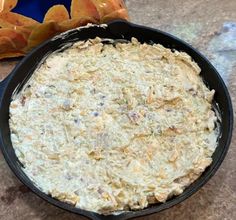 a black pan filled with food on top of a counter