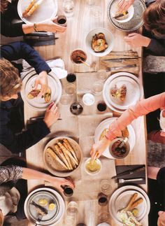 a group of people sitting around a table eating food