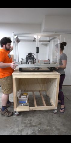 a man and woman working on an assembly project