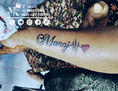 a person with a tattoo on their arm and the word manfi written in cursive writing