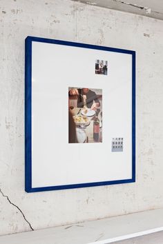 a white and blue frame hanging on the wall