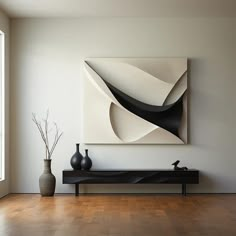 a large abstract painting hangs on the wall above a black and white bench with vases