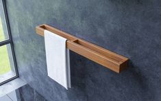 a towel rack mounted to the side of a wall