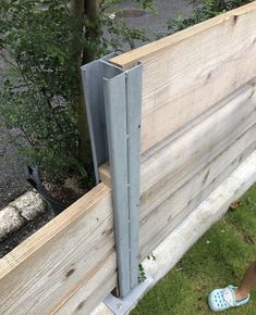 a person standing next to a wooden fence