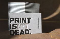 two white and black business cards with the words print is not dead printed on them