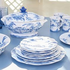 blue and white dishes are stacked on top of each other