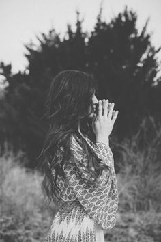 black and white photograph of woman in dress blowing her hair