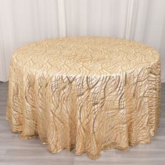 a round table with a gold cloth on it