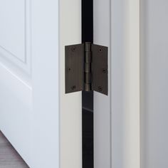 an open door with two black latches on it