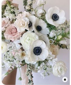 a bouquet of white and pink flowers in a vase