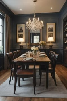 a dining room table with chairs and chandelier