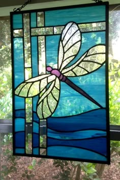 a stained glass window with a dragonfly on it