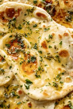 several flat breads with cheese and herbs on them