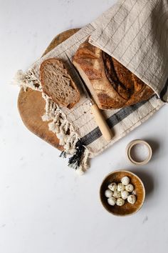 bread and marshmallows are sitting on a towel next to a small bowl