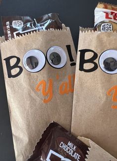 two brown paper bags with googly eyes and chocolate bars in them, one is for halloween