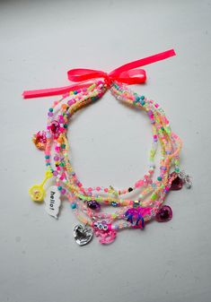 the bracelets are decorated with charms and ribbons