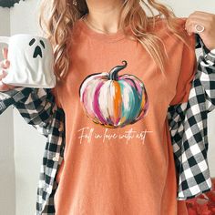 Searching for the perfect Fall Pumpkin Shirt Woman Comfort Colors, Cute Pumpkin TShirt for Fall in Love with Art Shirt, or Autumn Vibes Shirt for Halloween for Teen Girl; then look no further! -PRODUCT DESCRIPTION- Celebrate the beauty of autumn with this artistic "Fall Pumpkin Shirt." Featuring a hand-painted-style pumpkin and the inspiring message "Fall in Love with Art," this tee is perfect for those who appreciate creativity and the changing seasons. Crafted with Comfort Colors' soft-washed, garment-dyed fabric, this shirt offers both comfort and durability. Its relaxed fit and medium fabric weight make it ideal for casual outings, fall festivals, or cozy evenings spent enjoying the crisp autumn air. Made from 100% ring-spun US cotton, this tee is both comfortable and environmentally f Pumpkin Tshirt, Fall Festivals, Crisp Autumn, Inspiring Message, Art Shirt, Pumpkin Shirt, Autumn Vibes, Cute Pumpkin, Fall Festival